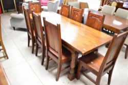 A nice quality reproduction oak refectory style dining table and set of eight similar chairs with