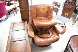 A Stressless armchair and footstool, in worn tan leather including some ripping to back