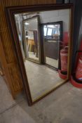 A modern mahogany effect wall mirror , approx. 102 x 70cm