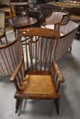 A traditional rocking chair having bobbin turned frame and ply seat