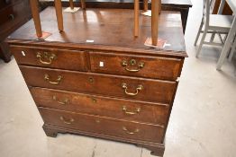 A Georgian oak and mahogany chest of two over three drawers having brass drop handles , on bracket