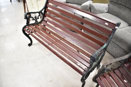 A traditional garden bench having cast ends and slatted seat, width approx. 130cm