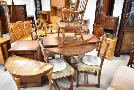 An Old Charm or similar (possibly Wood Bros) circular dining table and set of four ladder back