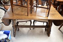A Priory style oak refectory dining table having drop ends, approx. 135 x 75cm closed.