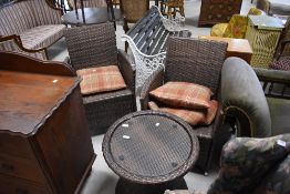 A modern weave effect garden/conservatory set comprising two arm chairs and glass topped