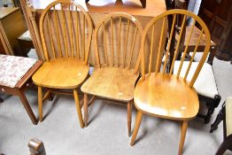 Three traditional hoop and stick back chairs , one possibly being Ercol