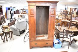 A late Victorian mahogany single mirror door wardrobe , having Art Nouveau style decoration