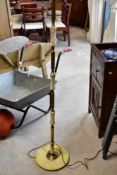 A vintage brass and onyx standard lamp