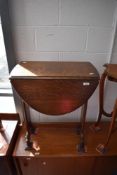 An early to mid 20th Century oak occasional table in the Gothic style with applique decoration