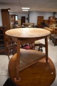 A traditional cricket table having circular top and triangular undertier, diameter approx. 82cm