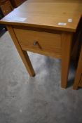 A modern golden oak side table with drawer, dimensions approx. W46 D46 H68cm