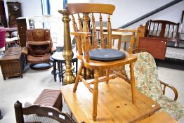 A reproduction rubberwood spindle back carver chair