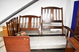 A pair of Edwardian mahogany single bed frames, labelled for Harrods, and sold with Staples 'Firm