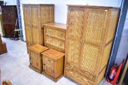 An Oriental style bamboo and wood bedroom suite comprising two wardrobes, chest of four long drawers