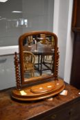 A Victorian light mahogany toilet mirror having trinket base and turned supports, width approx.
