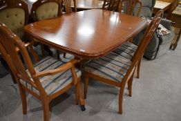 A reproduction Regency style yew wood twin pedestal dining table and set of five (three plus two)