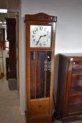 A 1930s long case clock bearing commemorative plaque to base, having been gifted by S Quin & Son Ltd