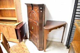 A 19th Century corner cupboard with later triangular table