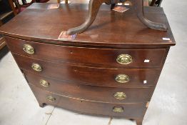 A 19th Century mahogany bow fronted chest of four long drawers having brass Regency style handles,