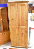 A modern natural pine single wardobe, dimensions approx. H187 W76 D53cm