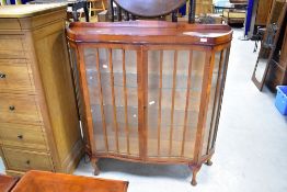 A vintage china cabinet having shaped front, width approx. 120cm