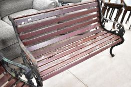 A traditional garden bench having cast ends and slatted seat, width approx. 130cm