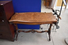 A Victorian walnut side table having shaped quarter veneered top on scroll frame, approx. 114 x