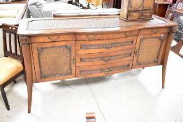 A reproduction sideboard in the classical style having woven fibre effect panelling, with four