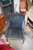 A late 19th or early 20th Century tub chair having embossed velvet upholstery on square tapered