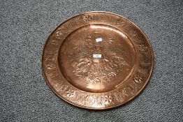 A large 20th-century Arts and Crafts presumed Keswick School of Industrial Arts copper charger,