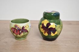 A small 20th-century Moorcroft Pottery 'Hibiscus' ginger jar and a 'Orchid' bud vase, both featuring