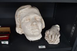 A 20th-century white plaster cast sculpture of a young female head, having a sweet expression with