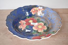 A early 20th-century Royal Doulton 'Wild Rose' high lustre bowl, featuring hand painted floral