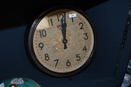 An early to mid 20th-century Smiths Sectric bakelite wall clock, featuring a yellowed dial face with