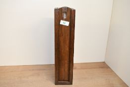 A tall late 19th to early 20th-century mahogany ecclesiastical candle box, featuring a sliding