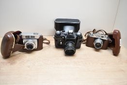 Three Cameras. A Zenit E with Helios 44-2 lens, a Halina 35X with Halina Angstigmat 1:3,5 45mm lens,