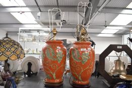 Two vintage pottery table lamp bases, of urn-like form featuring green scrolled grape vine motifs to