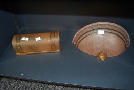 Two early 20th-century bakelite wall sconces, to feature a cylindrical and fan example, both