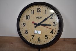 An early to mid 20th-century Smiths Sectric bakelite wall clock, featuring a yellowed dial face with