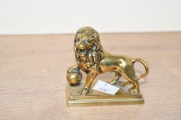 A fine 19th-century cast brass Medici lion sculpture, resting upon a integrated rectangular brass