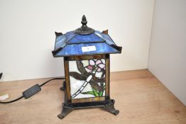 A vintage Kind Light Manufacturing Tiffany-style table lantern, featuring colourful panels with