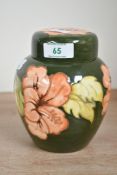 A 20th-century Moorcroft Pottery 'Hibiscus' ginger jar, featuring tube-lined coral-coloured floral