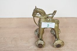 A small early 20th-century Indian brass temple toy, featuring a folk art-style horse with rider