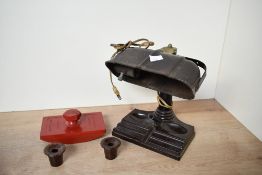 An early 20th-century Art Deco brown bakelite desk lamp with pen holder base, two inkwells and a