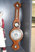 A Victorian brass mounted rose wood barometer, featuring traditional weather dial and built-in