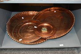 Four 20th-century decorative copper chargers, to feature two large Egyptian-examples with
