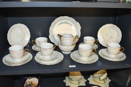 A vintage Czechoslovakian lustreware part tea set, featuring a pearlescent-type glaze with gilt
