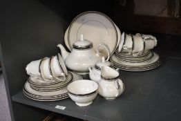 A 20th-century Royal Doulton fine bone china 'Sarabande' tea service, featuring black and gilt rim