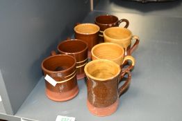 Seven small 20th-century Wetheriggs Pottery mugs, to feature two toned glazes, impressed to base, (