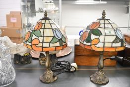 Two vintage Tiffany-style table lamps, featuring orange and blue floral Tulip-like motifs upon a